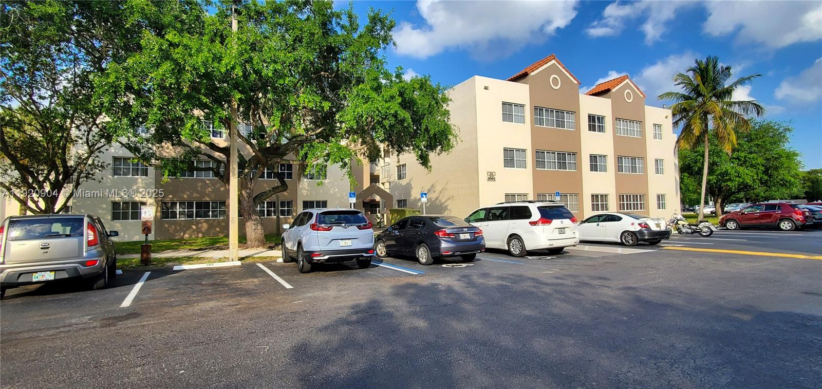 6065 Northwest 186th Street, Unit 106 Hialeah, FL 33015 - Photo 17 of 20 a view of cars parked in front of a house