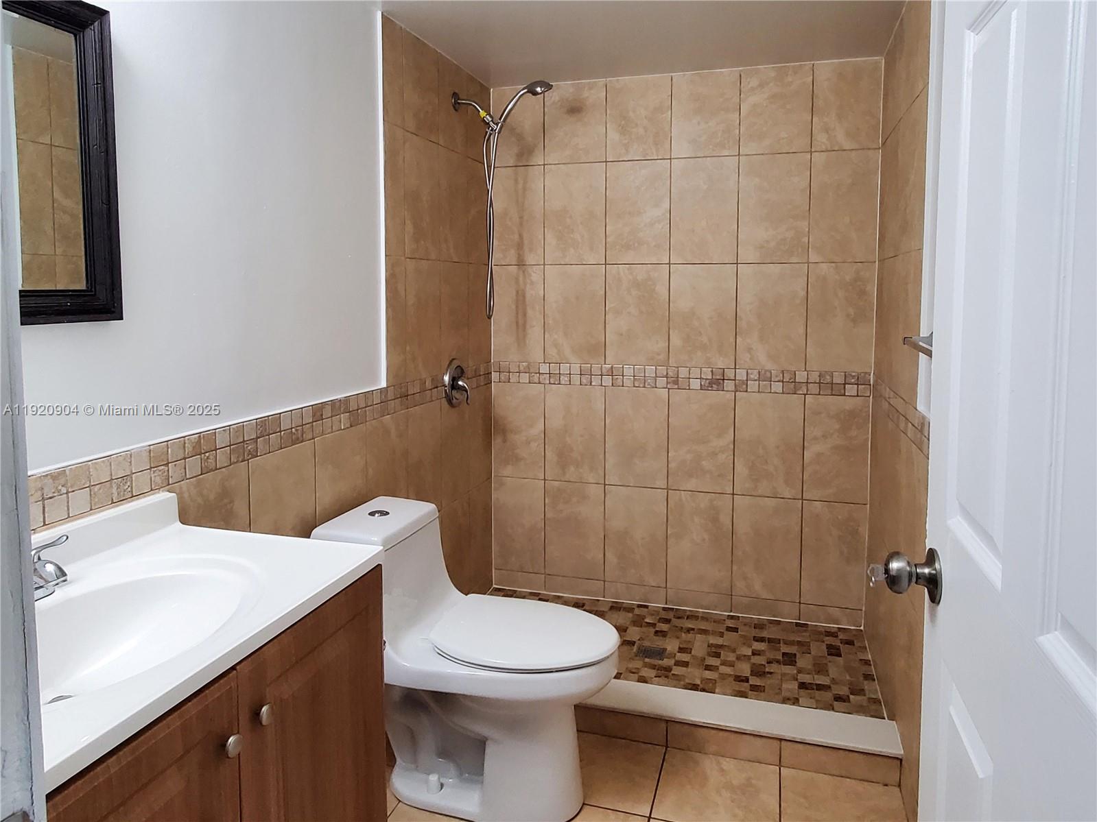 6065 Northwest 186th Street, Unit 106 Hialeah, FL 33015 - Photo 3 of 20 a bathroom with a sink a toilet and shower