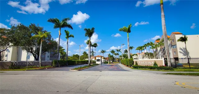 a view of a house with a yard and a street