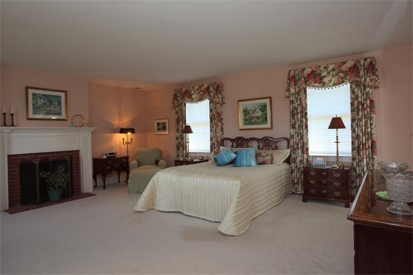 188 Prospect Hill Road Harvard, MA 01451 - Photo 19 of 30 a bedroom with a bed and a fireplace