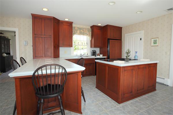 188 Prospect Hill Road Harvard, MA 01451 - Photo 9 of 30 a kitchen with stainless steel appliances granite countertop a sink a stove a refrigerator cabinets and a dining table