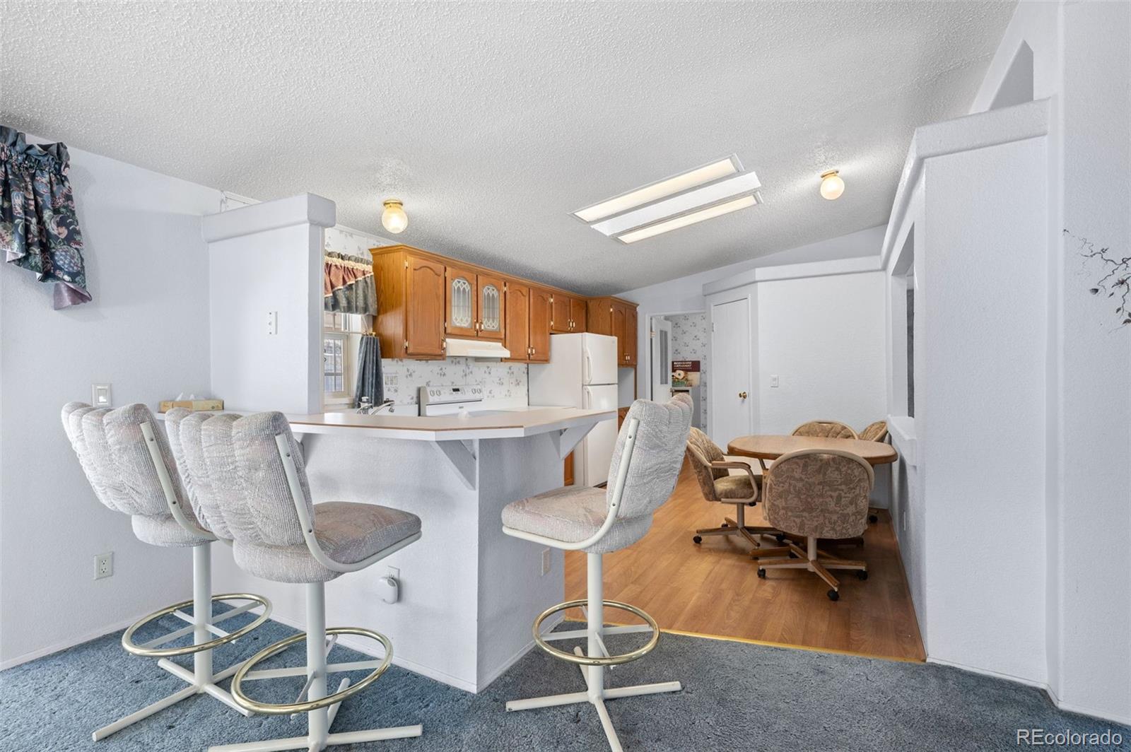 185 Elm Street Hudson, CO 80642 - Photo 13 of 43 a workspace with furniture and wooden floor
