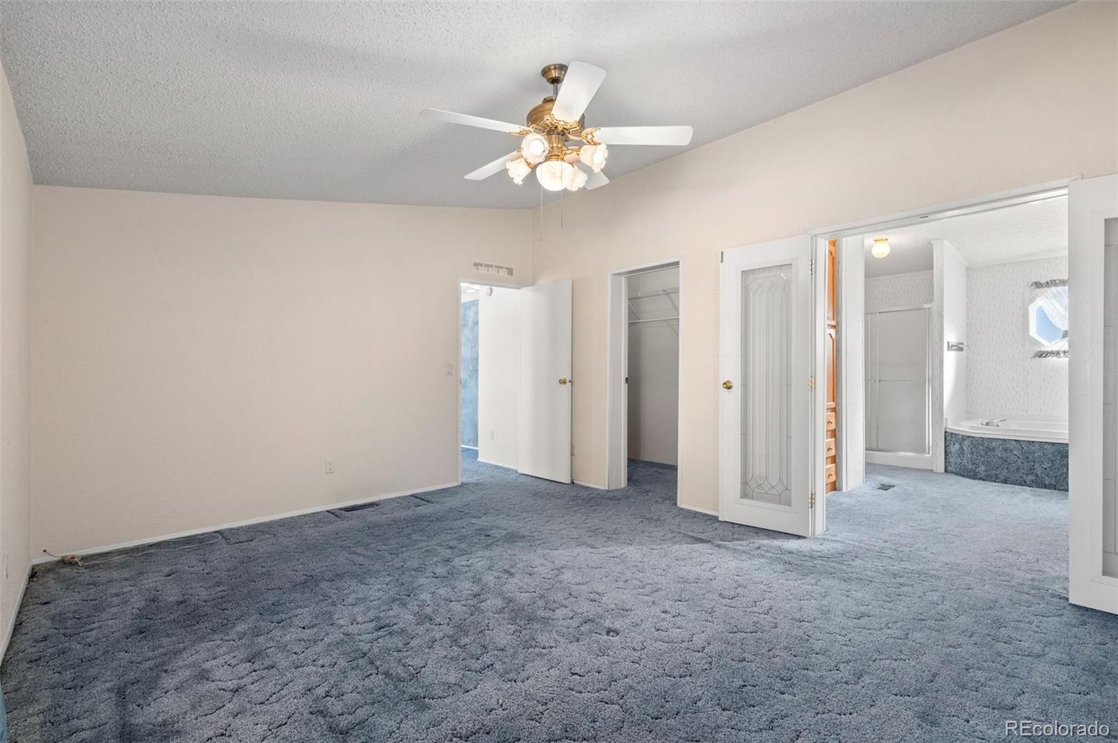 185 Elm Street Hudson, CO 80642 - Photo 21 of 43 an empty room with fan and entrance