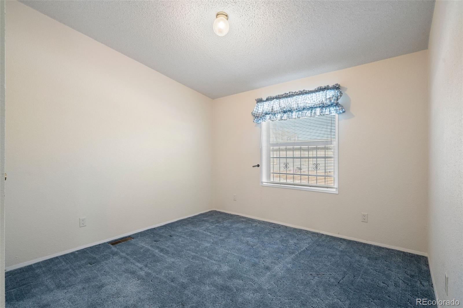 185 Elm Street Hudson, CO 80642 - Photo 28 of 43 an empty room with a window