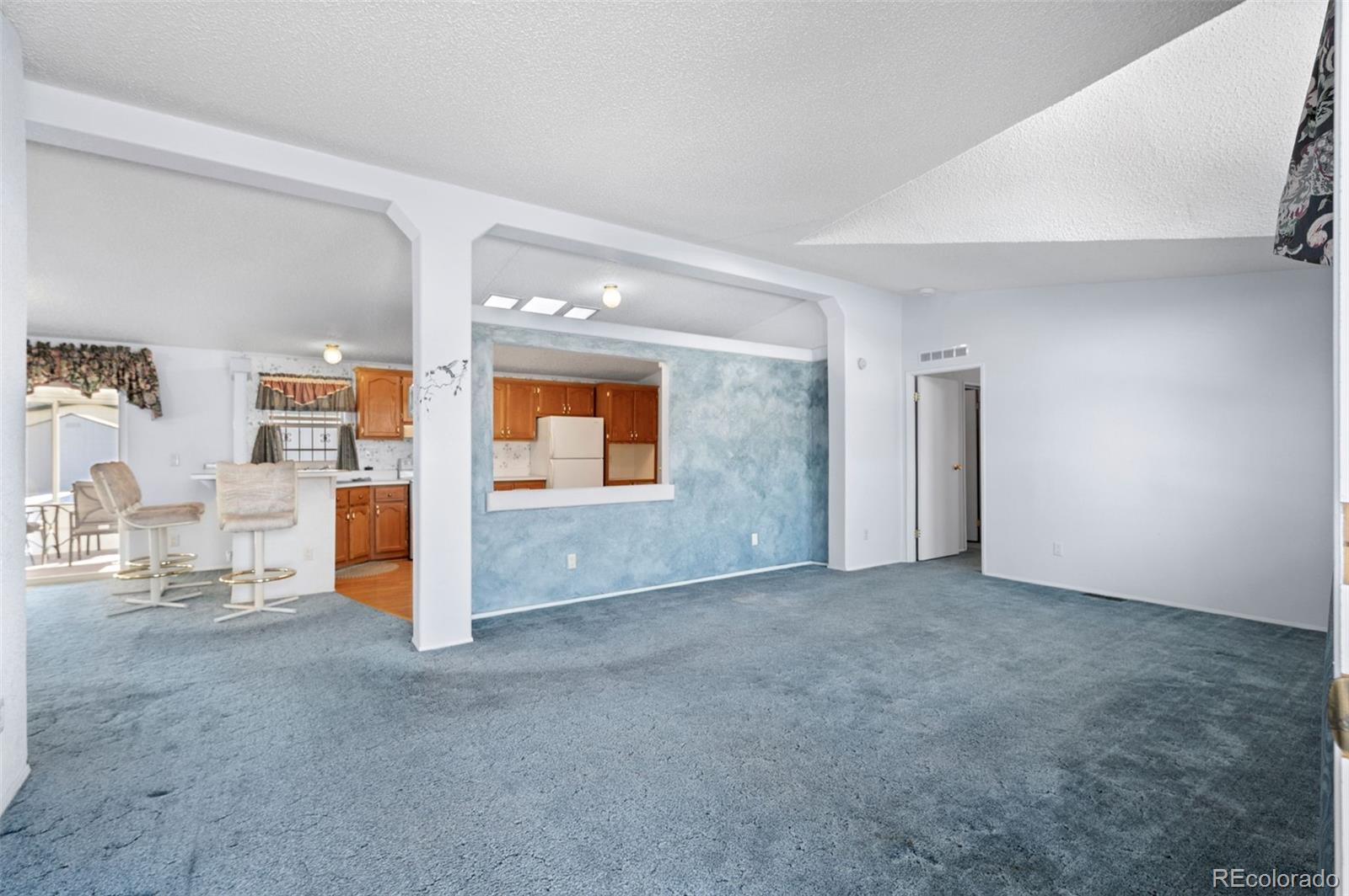 185 Elm Street Hudson, CO 80642 - Photo 5 of 43 an empty room with closet and mirrors