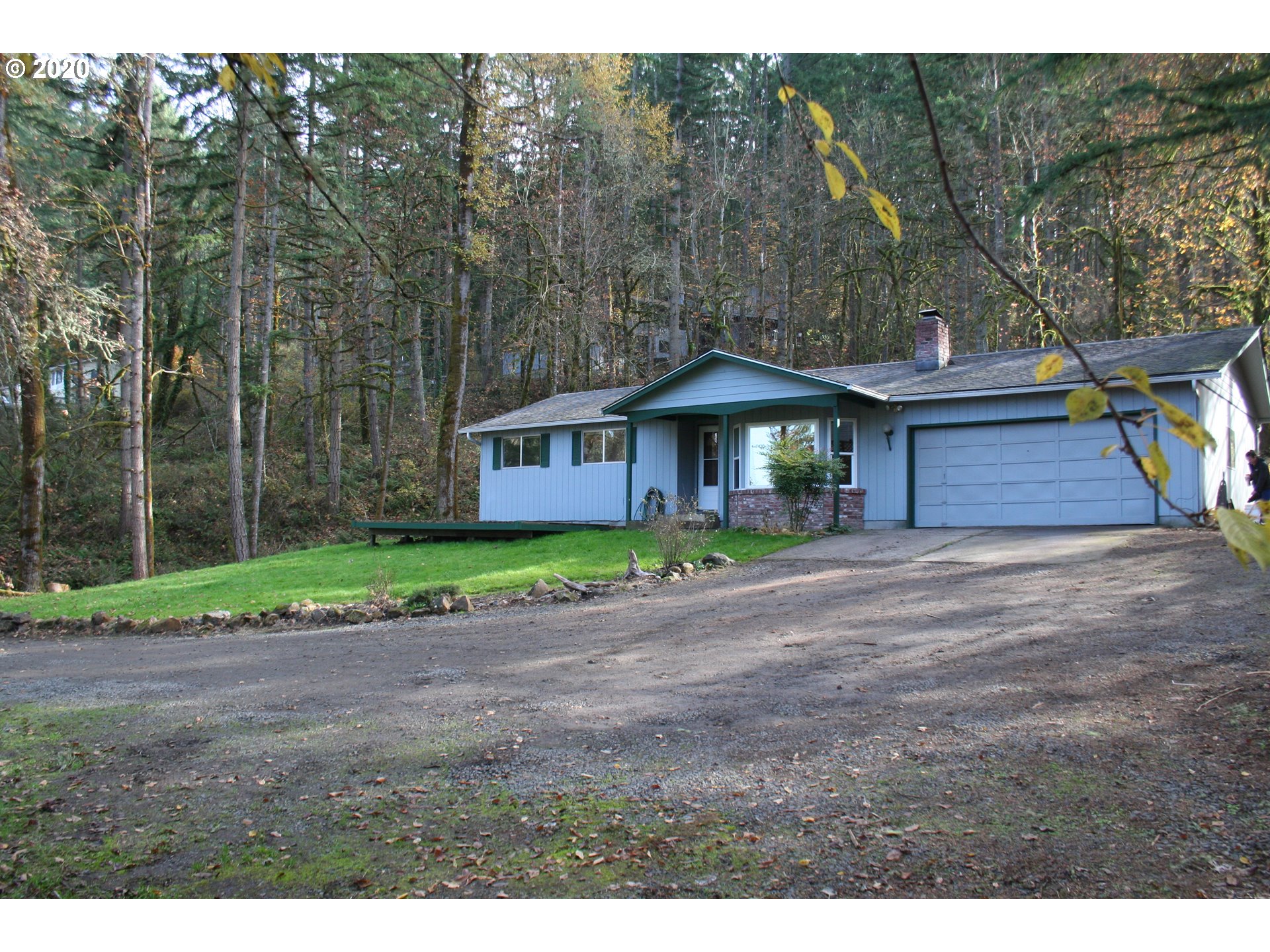 1042 South 70th Street Springfield, OR 97478 - Photo 4 of 18 a front view of a house with a garden and trees