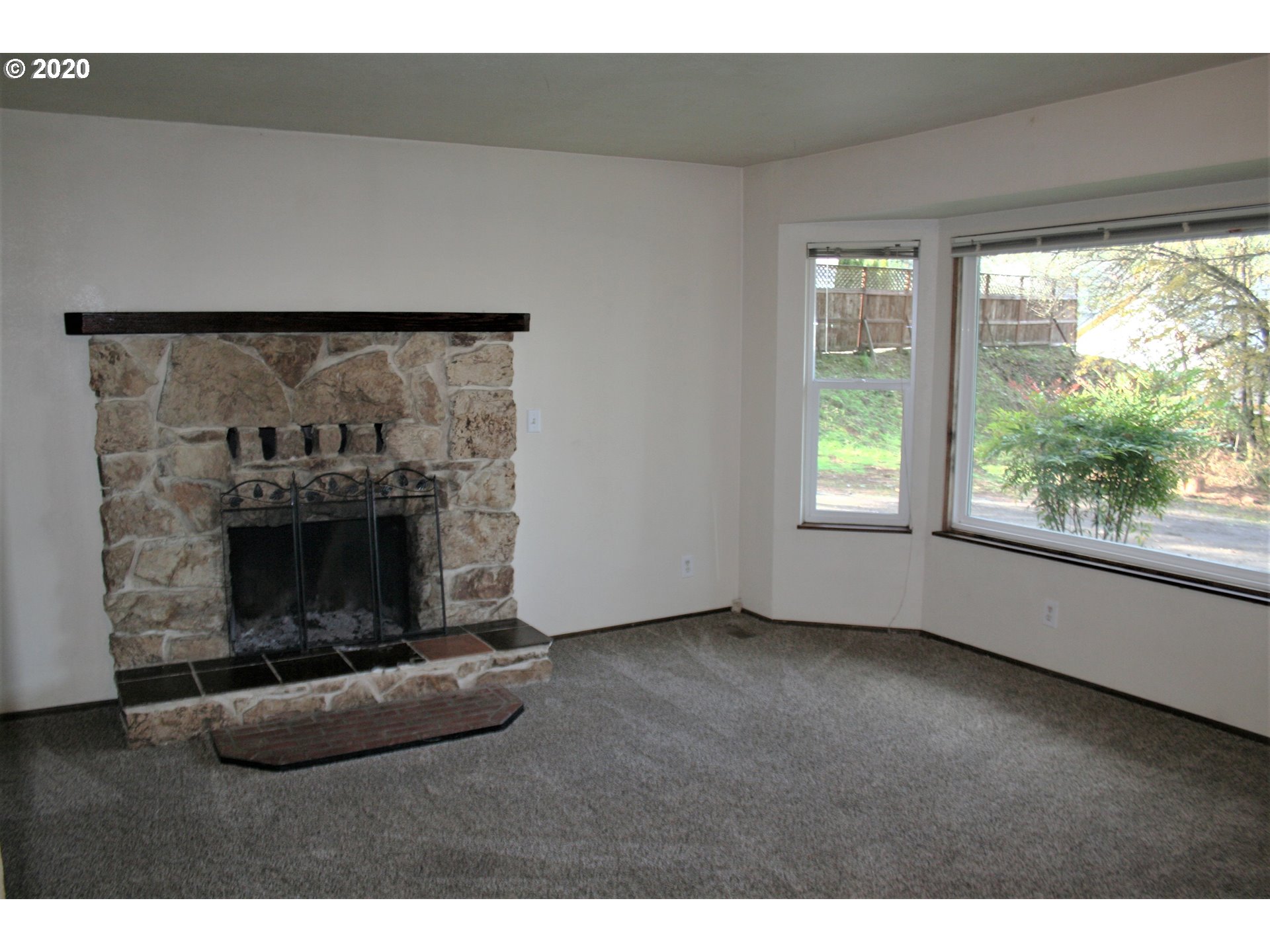 1042 South 70th Street Springfield, OR 97478 - Photo 8 of 18 a living room with furniture and a fireplace