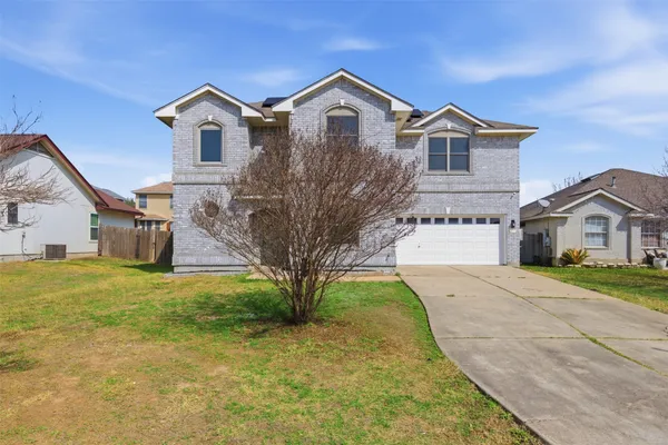 a front view of a house with a yard and garage