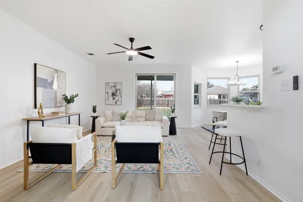 a living room with furniture a rug and white walls