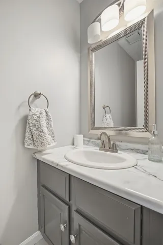 a bathroom with a double vanity sink mirror and toilet