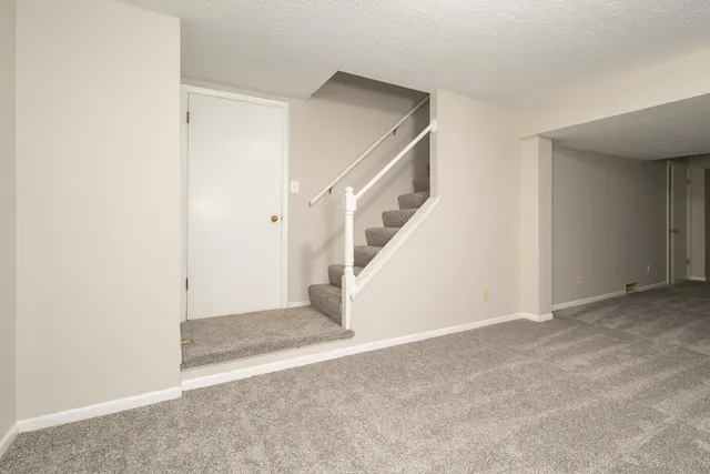 a view of an empty room with a kitchen