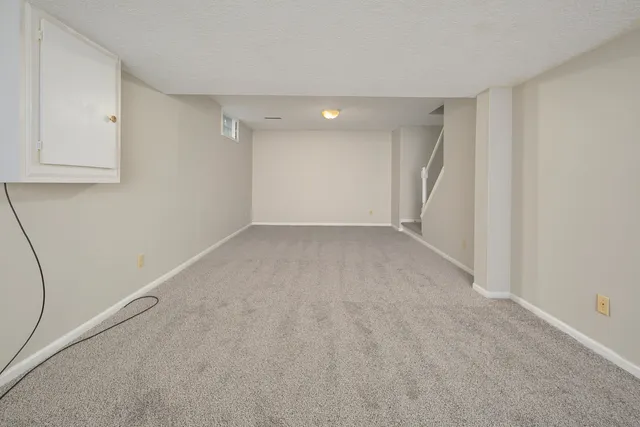 a front view of a house with a garden and yard