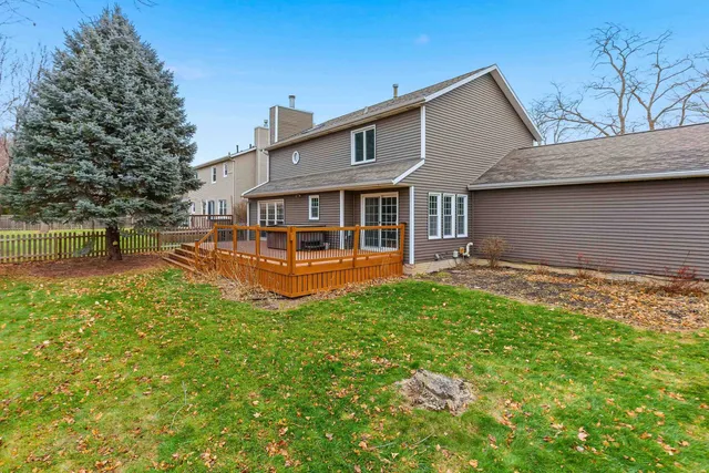 a view of a house with a barbeque grill and wooden floor