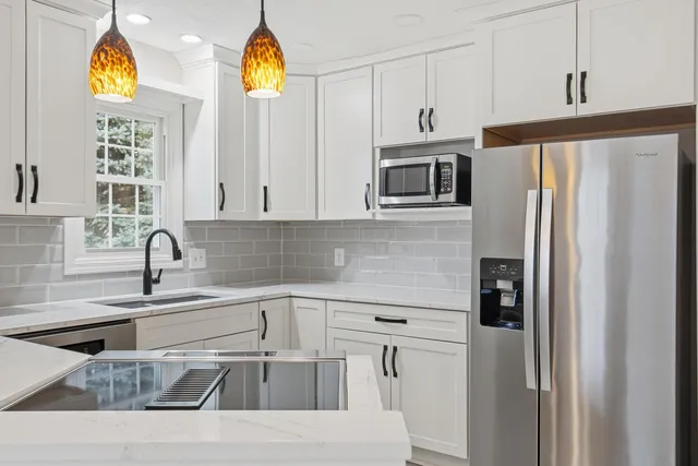 a kitchen with a stove a sink and a refrigerator