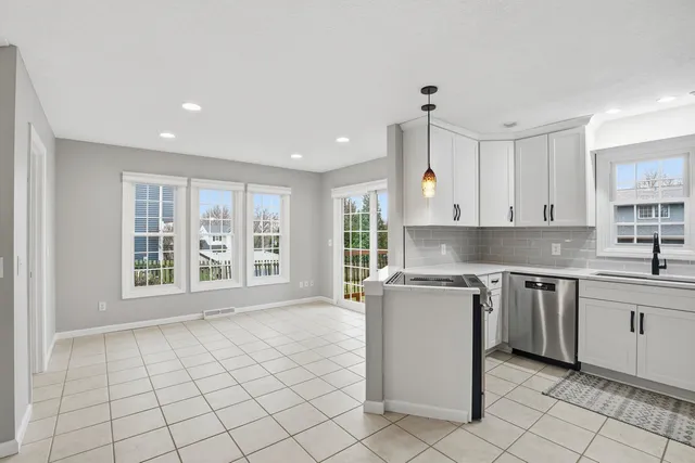 a kitchen with stainless steel appliances a refrigerator and a stove top oven