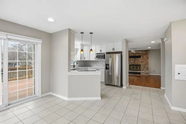 a kitchen with stainless steel appliances white cabinets and a sink