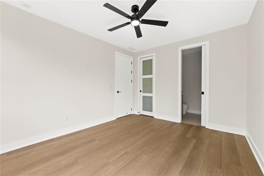 7066 Bells Way Fairburn, GA 30213 - Photo 43 of 64 an empty room with wooden floor and windows