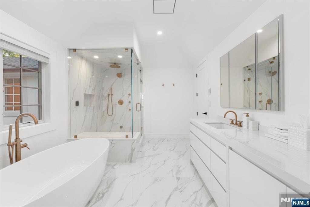 306 Hutchinson Road Englewood, NJ 07631 - Photo 21 of 50 a spacious bathroom with a bathtub shower sink double and mirror