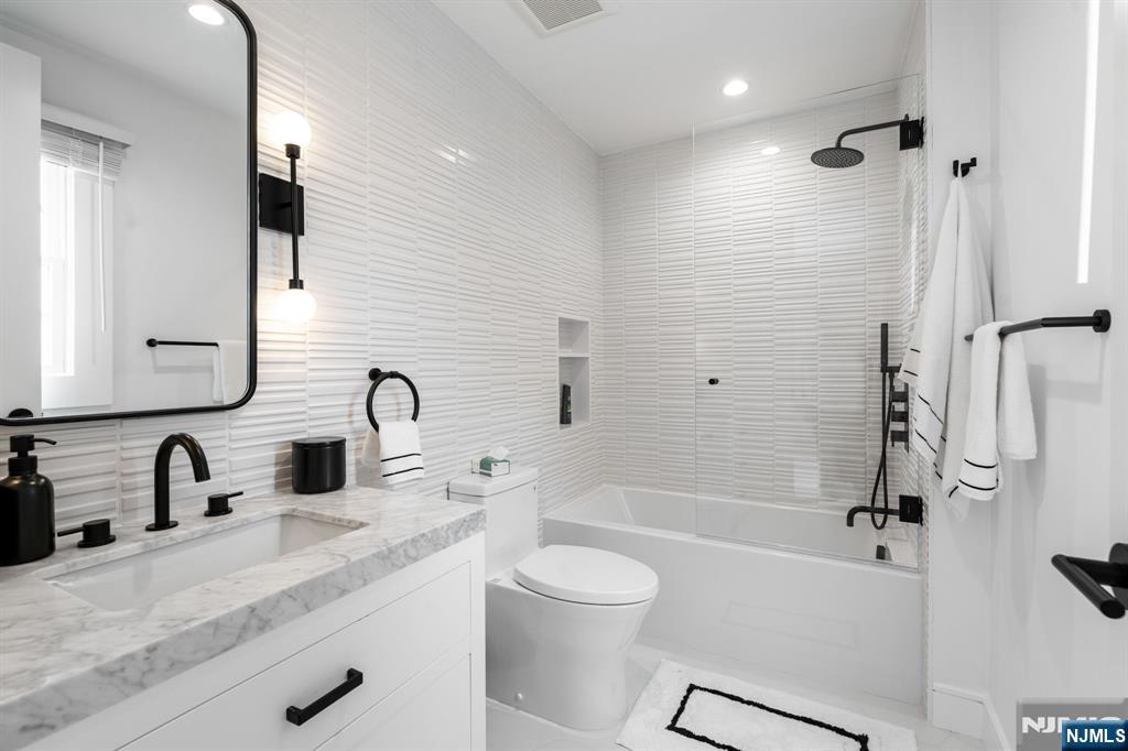 306 Hutchinson Road Englewood, NJ 07631 - Photo 24 of 50 a bathroom with a granite countertop sink toilet and shower