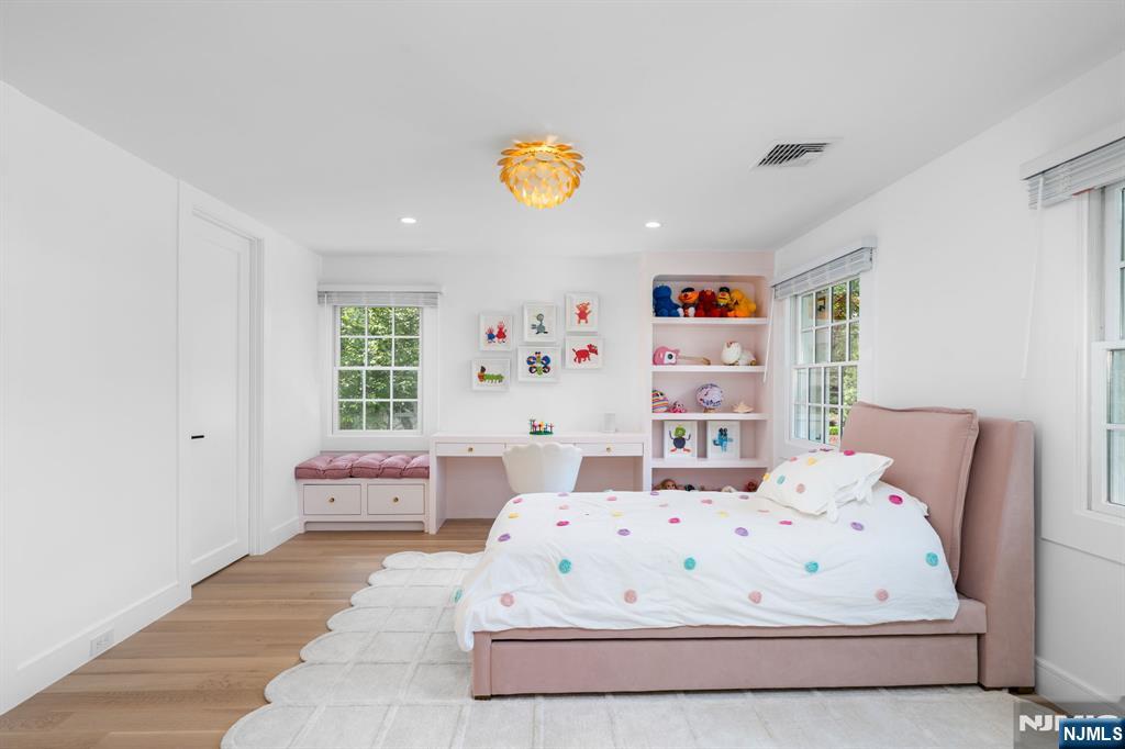 306 Hutchinson Road Englewood, NJ 07631 - Photo 25 of 50 a large white bed sitting in a bedroom next to a window