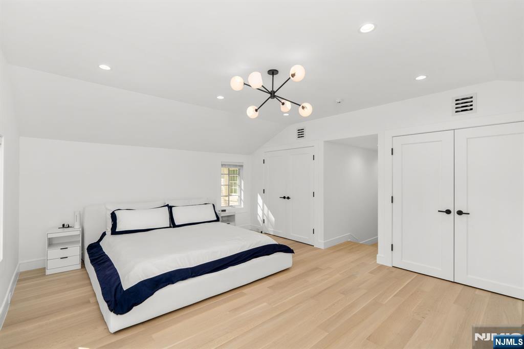 306 Hutchinson Road Englewood, NJ 07631 - Photo 27 of 50 a bedroom with a bed and a ceiling fan