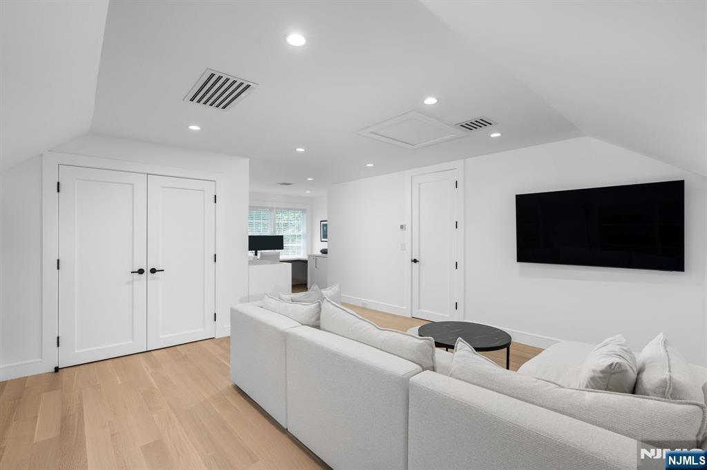 306 Hutchinson Road Englewood, NJ 07631 - Photo 29 of 50 a living room with furniture and a flat screen tv