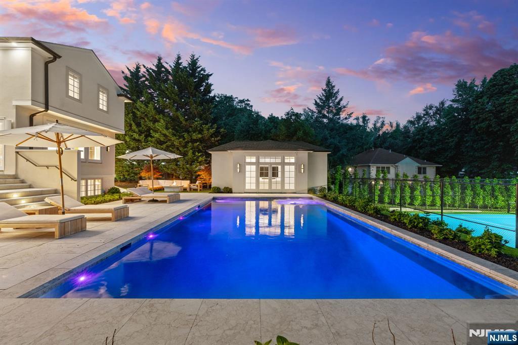 306 Hutchinson Road Englewood, NJ 07631 - Photo 43 of 50 a view of swimming pool with outdoor seating and city in the background