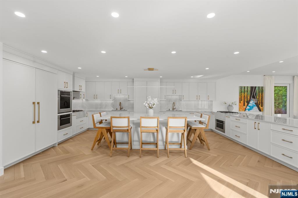 306 Hutchinson Road Englewood, NJ 07631 - Photo 5 of 50 a large kitchen with lots of counter space and stainless steel appliances