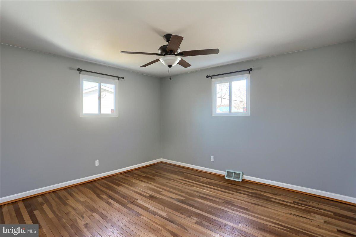 104 Cedarcliff Court Glen Burnie, MD 21060 - Photo 11 of 34 wooden floor in an empty room with a window