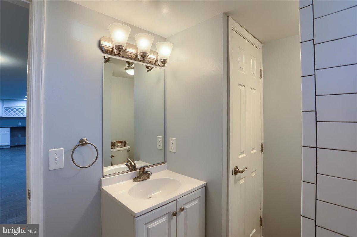 104 Cedarcliff Court Glen Burnie, MD 21060 - Photo 23 of 34 a bathroom with a sink vanity and a mirror
