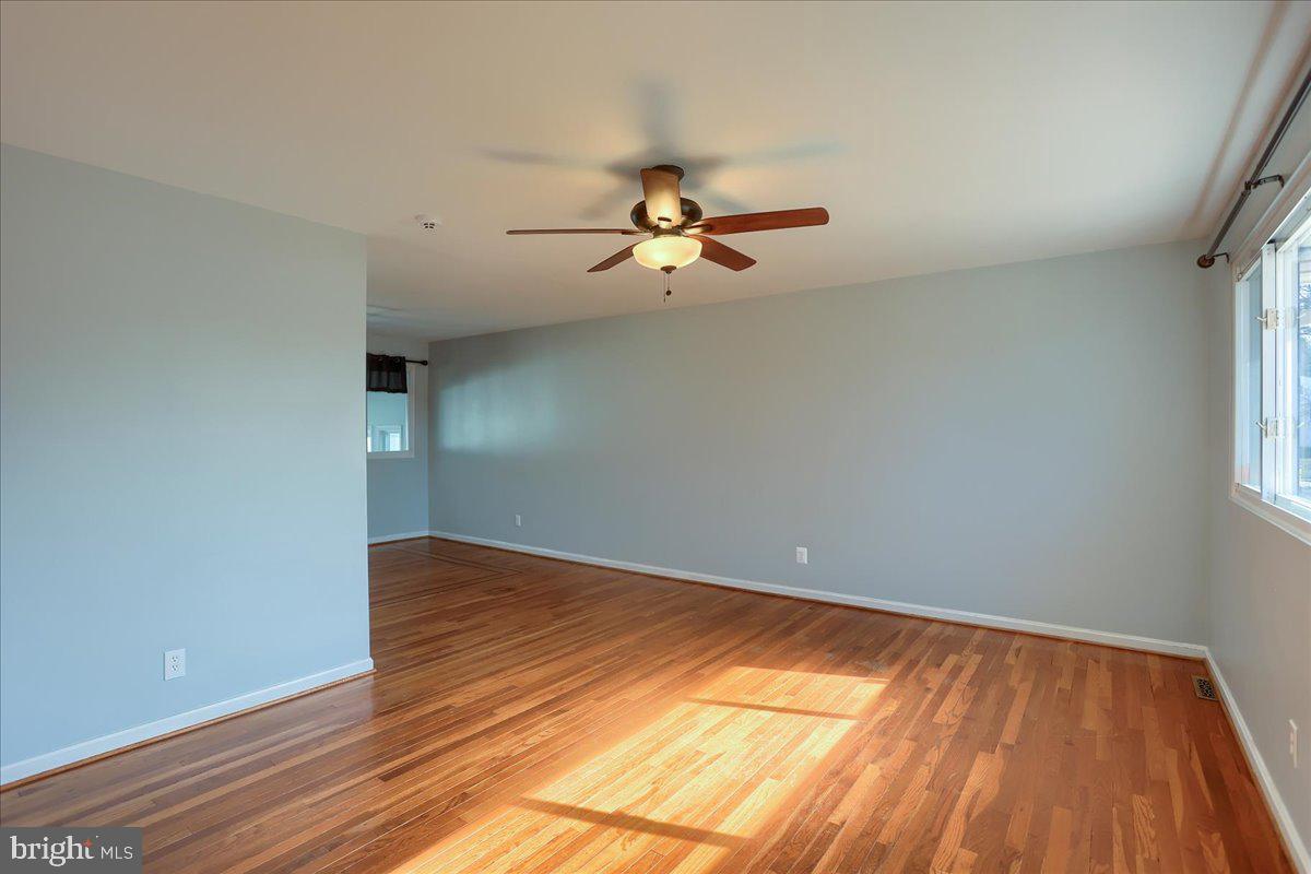 104 Cedarcliff Court Glen Burnie, MD 21060 - Photo 4 of 34 wooden floor in an empty room with a window