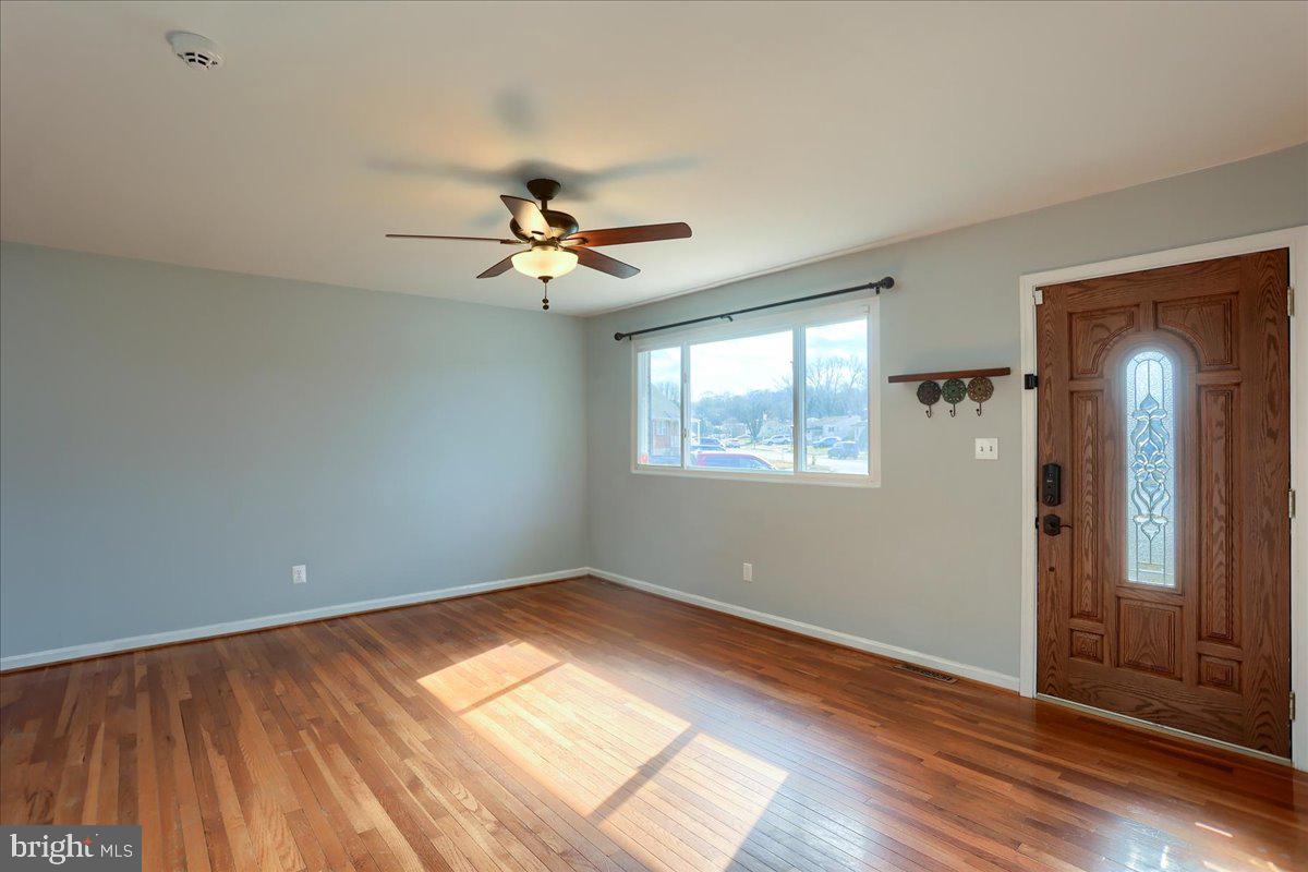 104 Cedarcliff Court Glen Burnie, MD 21060 - Photo 5 of 34 a view of empty room with wooden floor and fan
