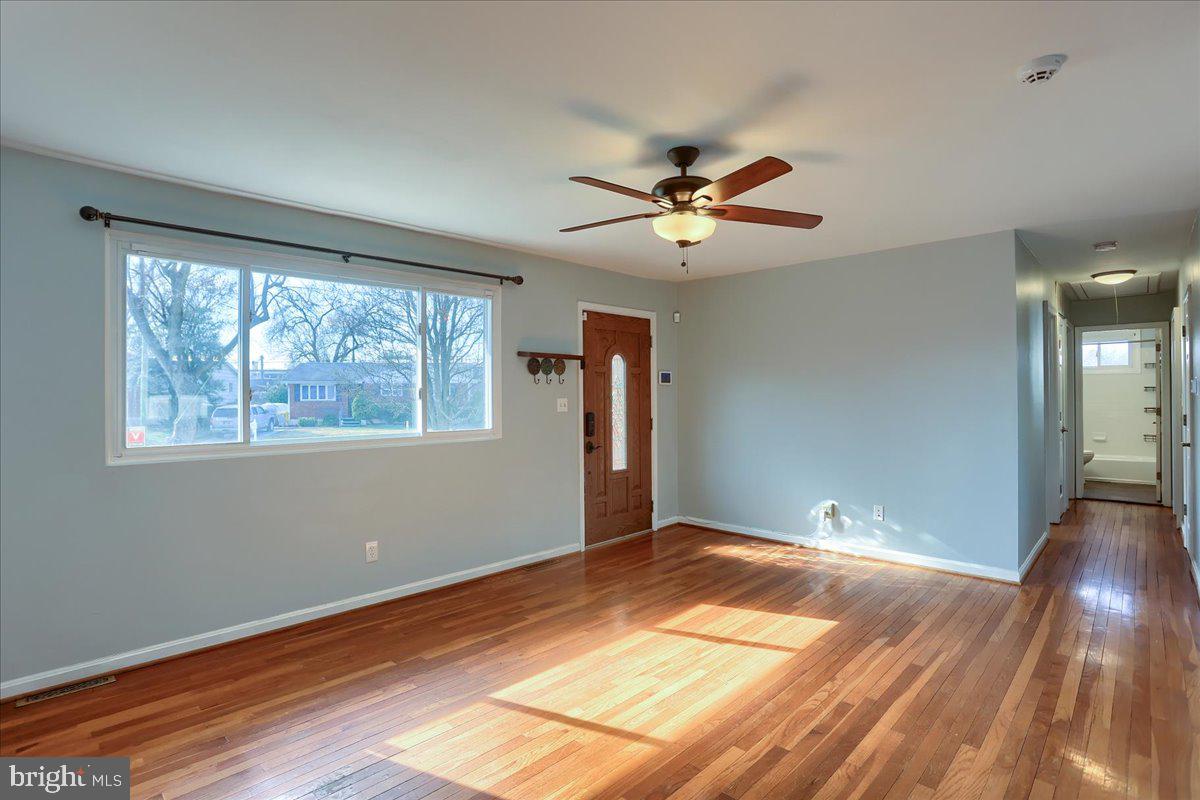 104 Cedarcliff Court Glen Burnie, MD 21060 - Photo 6 of 34 a view of empty room with wooden floor and fan
