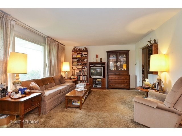 401 Warren Road Glenview, IL 60025 - Photo 3 of 10 a living room with furniture and a flat screen tv