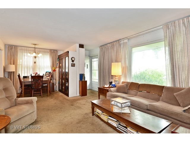 401 Warren Road Glenview, IL 60025 - Photo 4 of 10 a living room with furniture and a large window