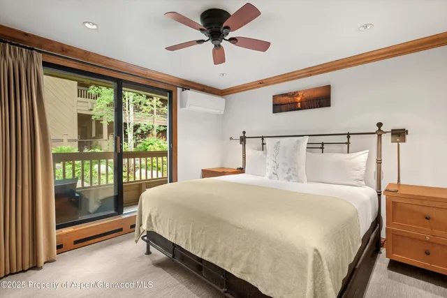 a bedroom with a bed and a ceiling fan