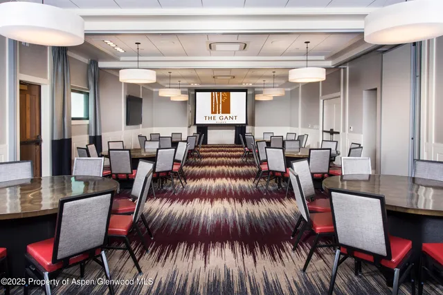 an aerial view of a residential apartment building with a yard and garden space