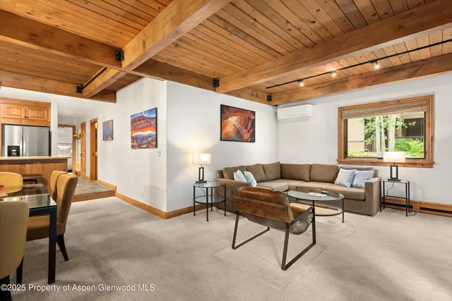 a living room with furniture a window and a table