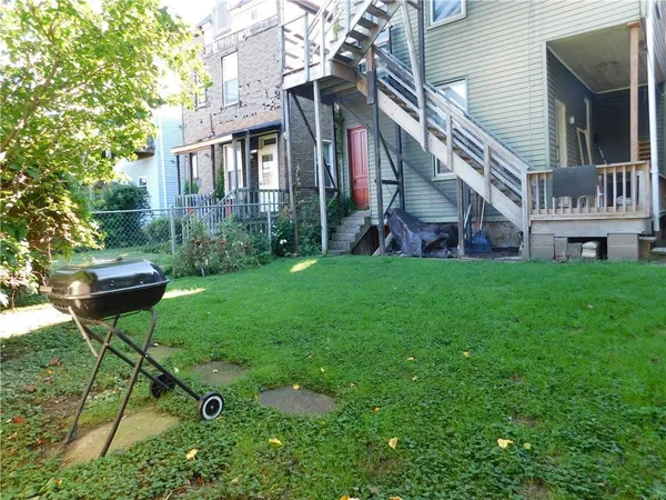 a house view with a sitting space and garden
