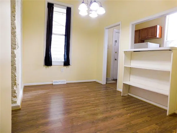 a view of a livingroom with wooden floor and a flat screen tv