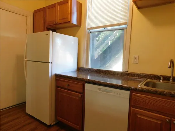 a kitchen with a refrigerator and a sink