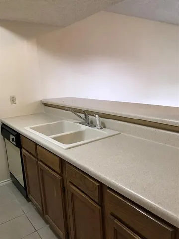 an empty room with a ceiling fan and fan