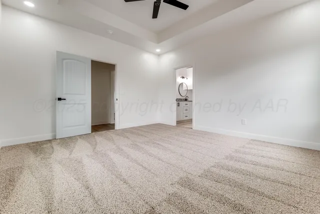a view of empty room with ceiling fan