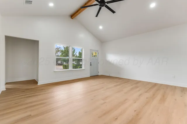wooden floor in an empty room with a window