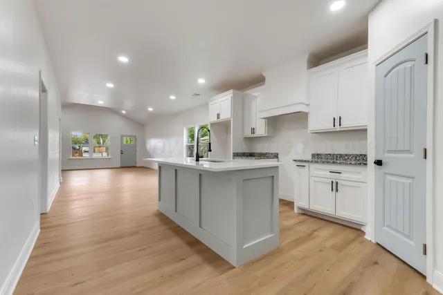 a kitchen with white cabinets and a sink