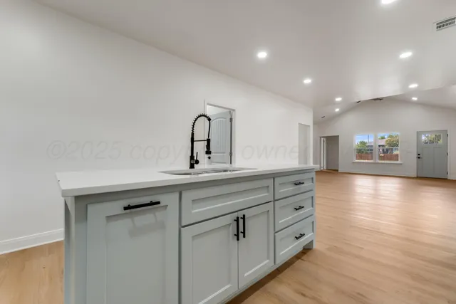 a view of a kitchen counter space with wooden floor