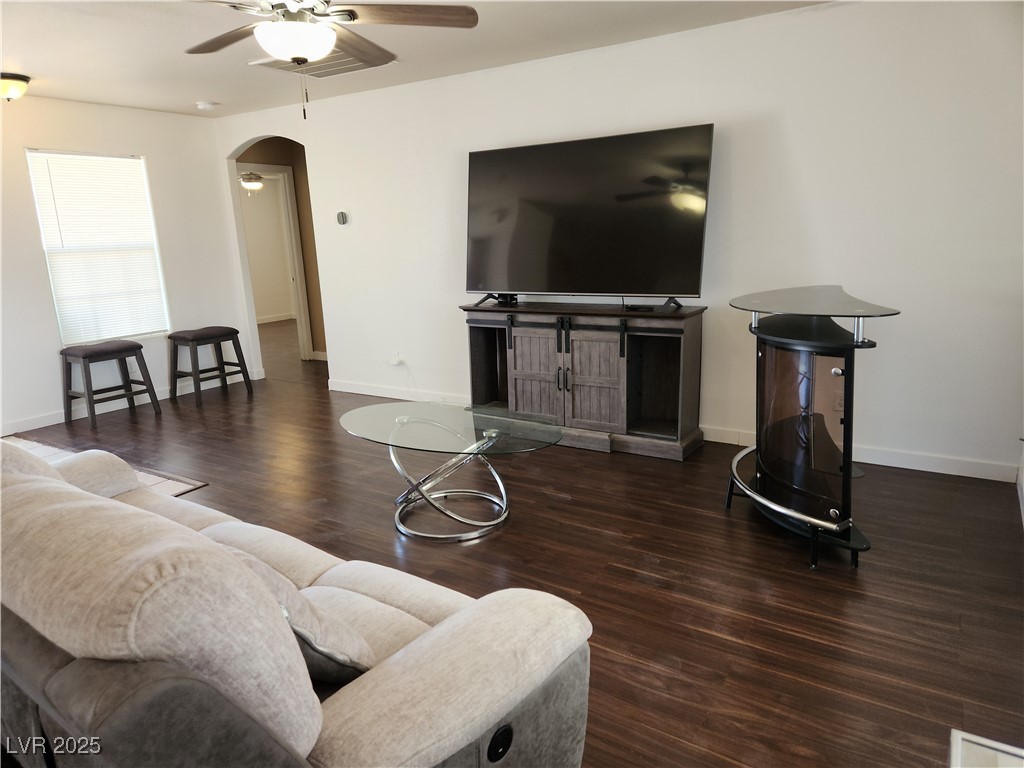 161 Diamond Bar Road Pahrump, NV 89048 - Photo 5 of 29 Living room with arched walkways, ceiling fan, and wood finished floors