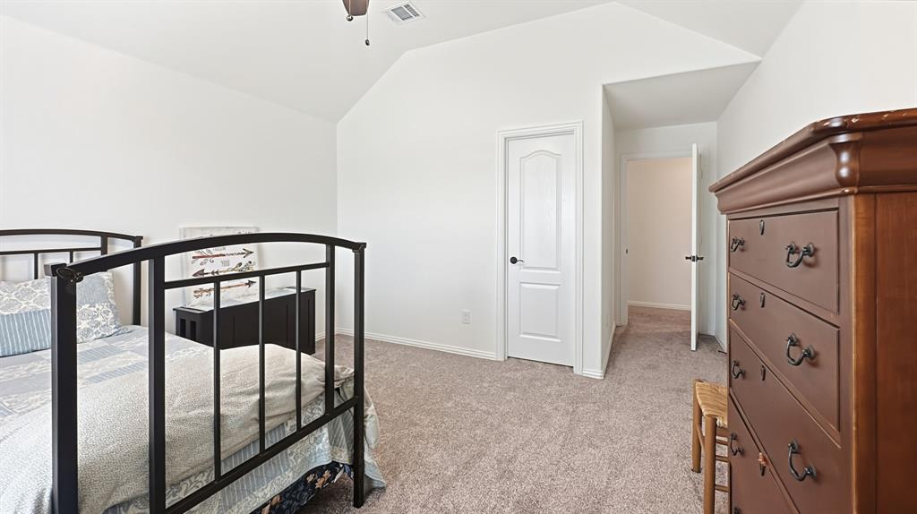 5216 Troupe Road McKinney, TX 75071 - Photo 28 of 40 Carpeted interior space featuring a vaulted ceiling with a ceiling fan
