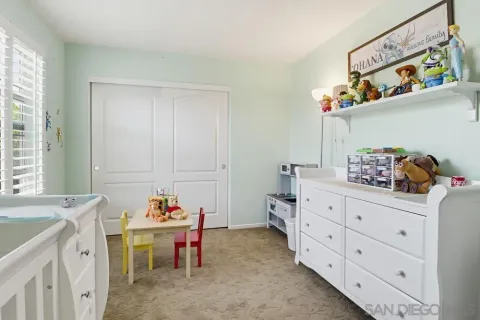 a room with furniture a baby crib and a window