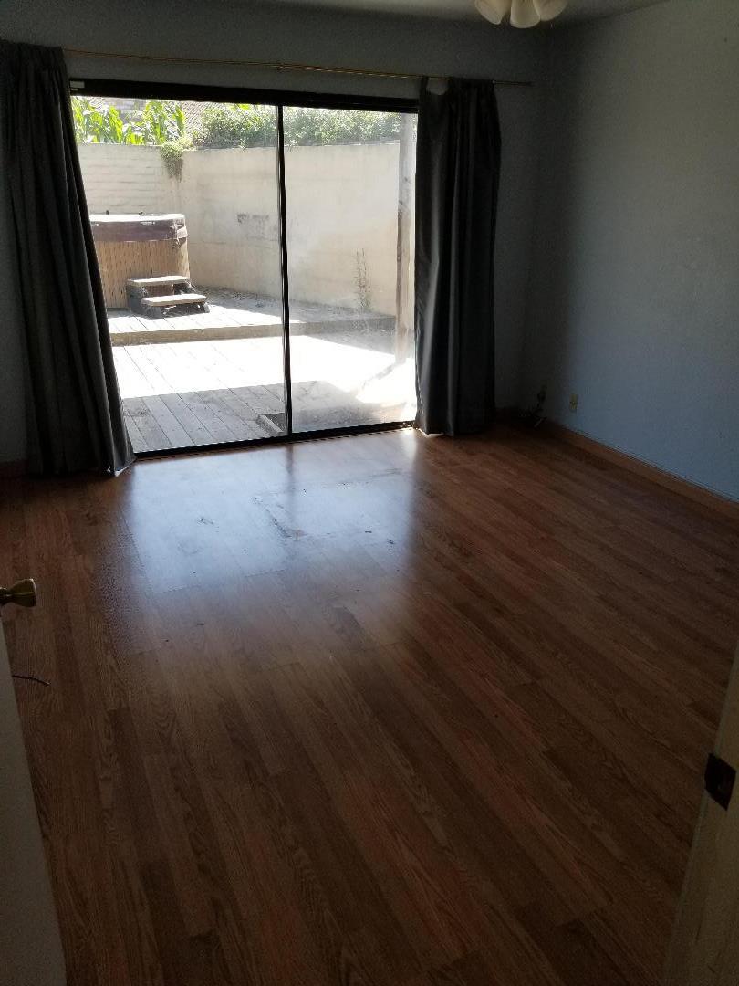569 Powell Street Salinas, CA 93907 - Photo 11 of 14 a view of an empty room with wooden floor and a window